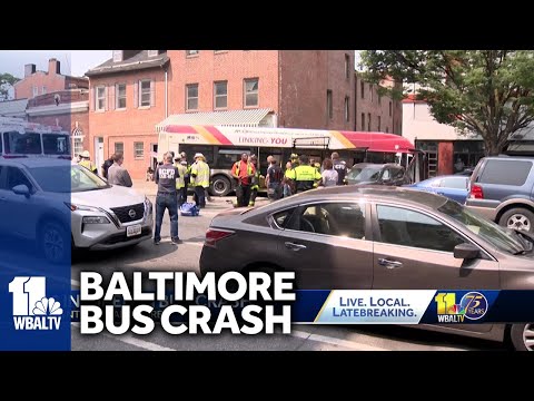 Chain-reaction crash leads bus to hit building